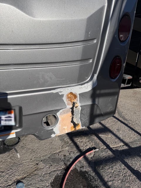 Damaged lower rear fiberglass wall on a 2026 Jayco Seneca Prestige 37M motorhome before repair in Las Vegas