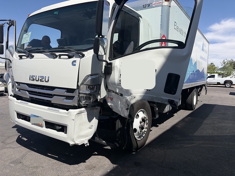Isuzu FTR HD box truck with left-front collision damage before structural repair