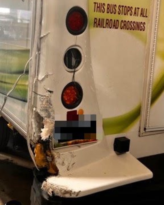 Close-up of the shattered fiberglass rear corner and taillight housing on a commercial shuttle bus before repair in Las Vegas